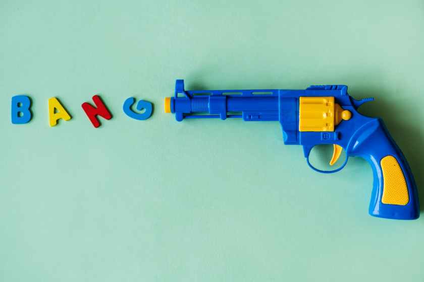 blue and yellow plastic toy revolver pistol