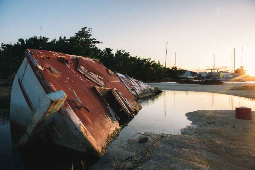 an abandoned boat on water